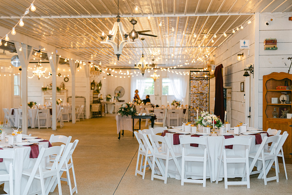 Elegant barn reception in North Georgia with rustic decor, refined lighting, and personalized wedding details