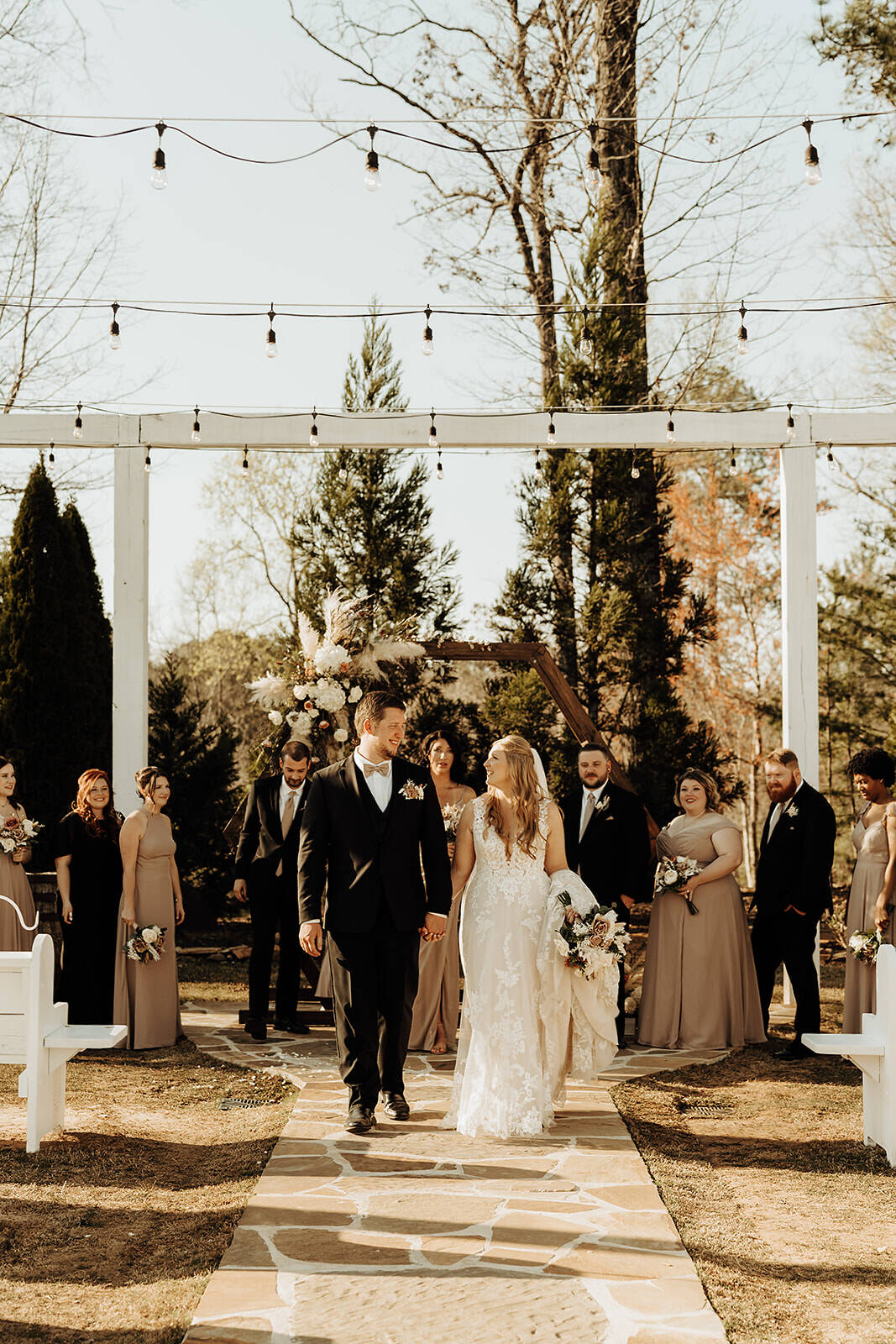 Elegant black tie wedding at a barn venue with formal attire and rustic charm